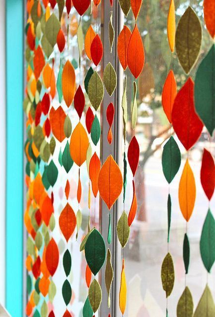 a close up of a window with a curtain made out of leaves