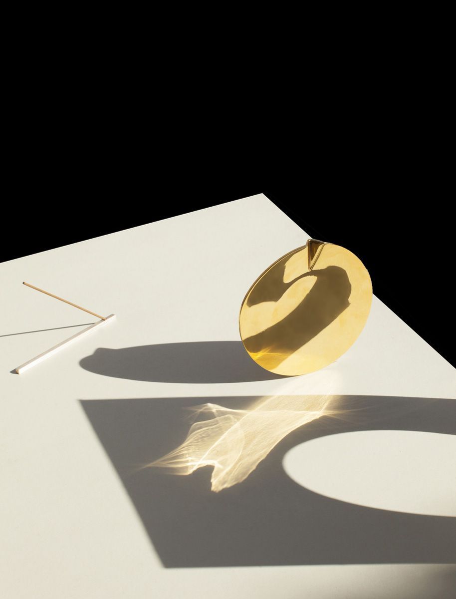 a golden object sitting on top of a white table