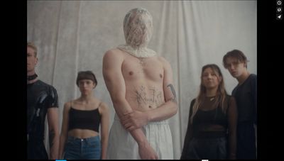 a group of people standing in front of a white wall