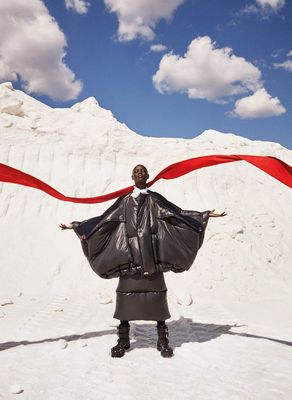 a woman holding a red scarf in the snow