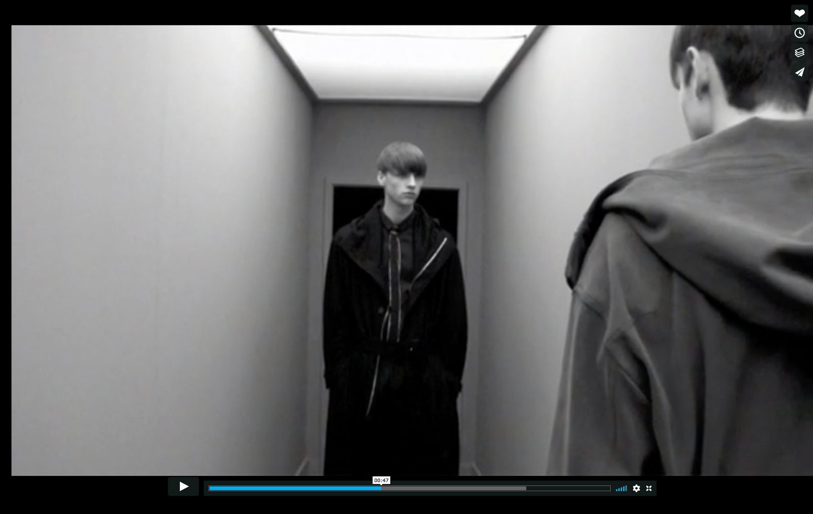 a man standing in a hallway next to another man