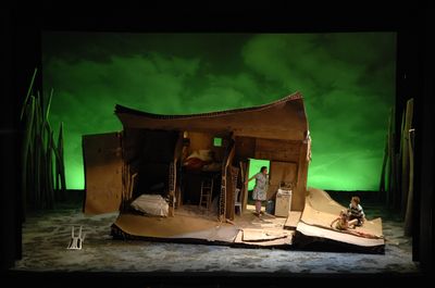 a stage set with a man and a woman in a boat