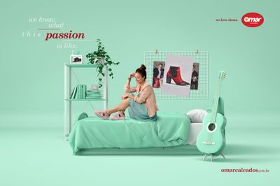 a woman sitting on a bed with a green bed spread