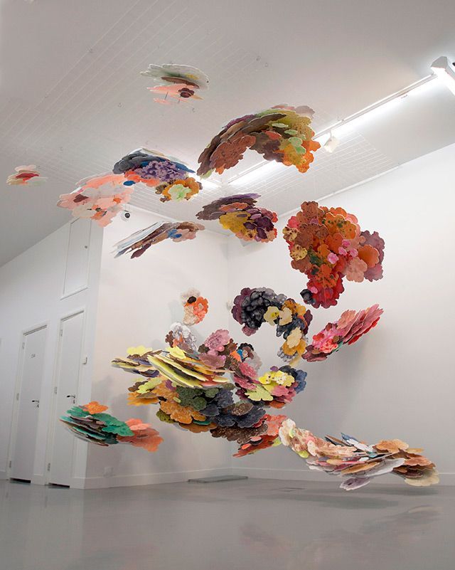 a room with a bunch of paper flowers flying in the air