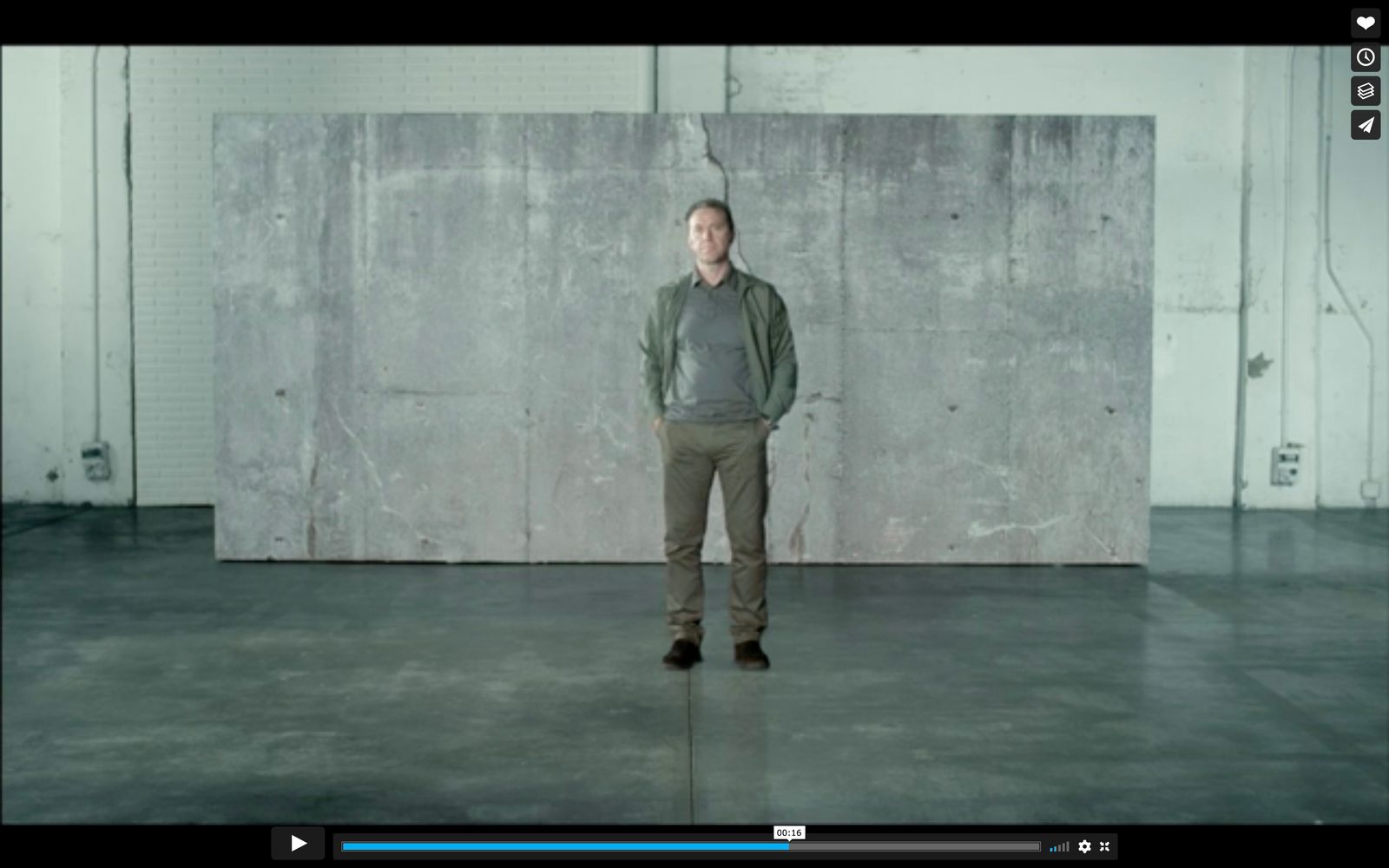 a man standing in front of a concrete wall