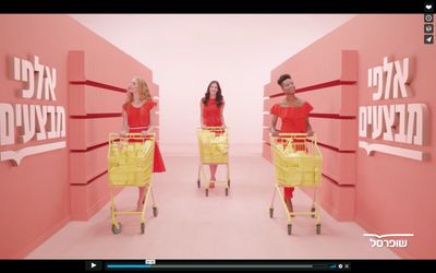 a group of women standing in front of a pink wall