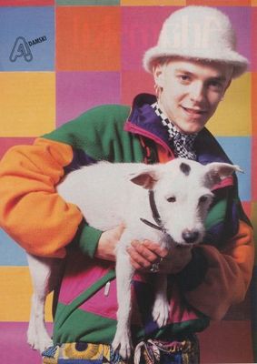 a man holding a white dog in his arms