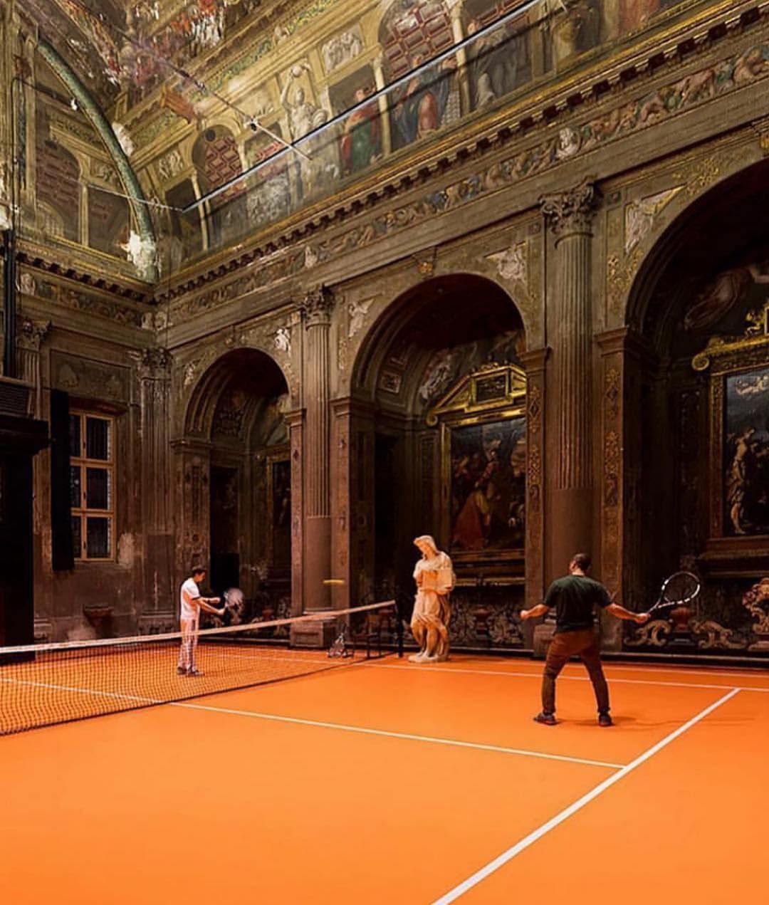 a group of people playing a game of tennis