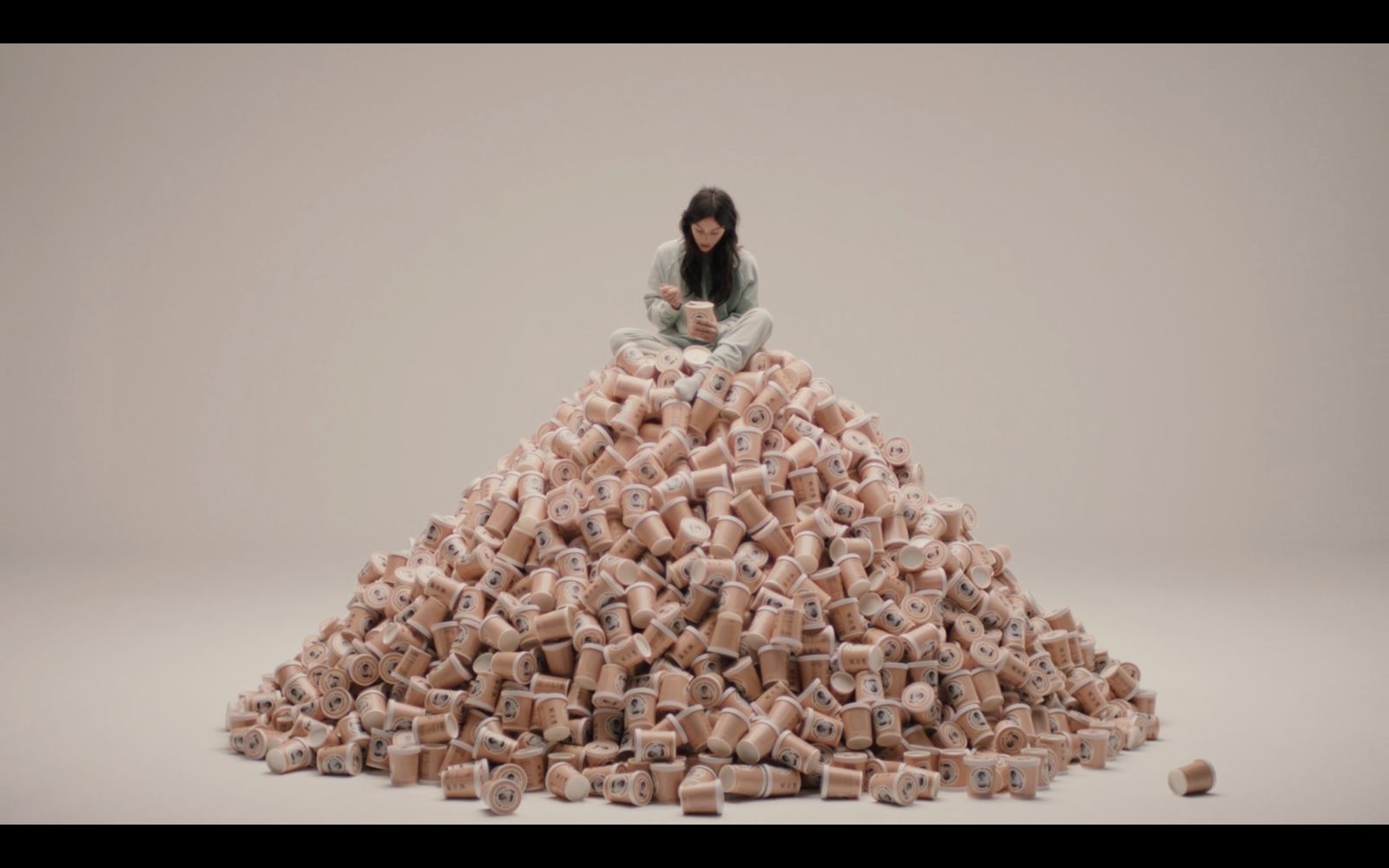 a woman sitting on top of a pile of bricks