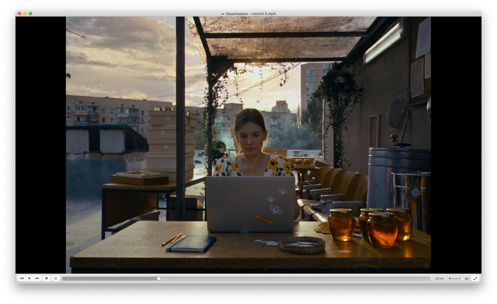 a woman sitting at a table using a laptop computer