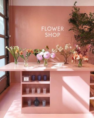 a flower shop with vases of flowers on the counter