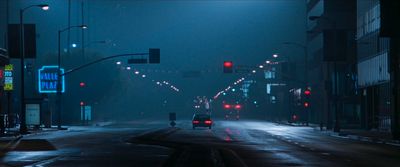 a car driving down a street at night