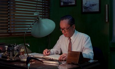 a man sitting at a desk in front of a book