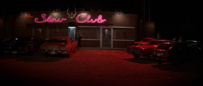 a red neon sign that reads the saloon club