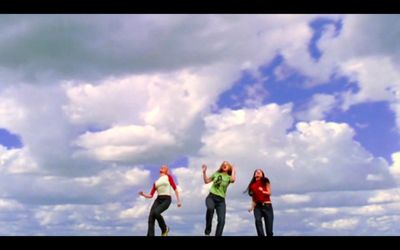 a group of people flying a kite in the sky