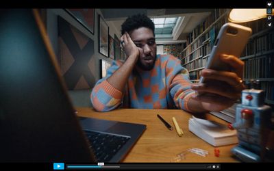 a man sitting in front of a laptop computer