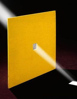 a bright light shines through the opening of a yellow book