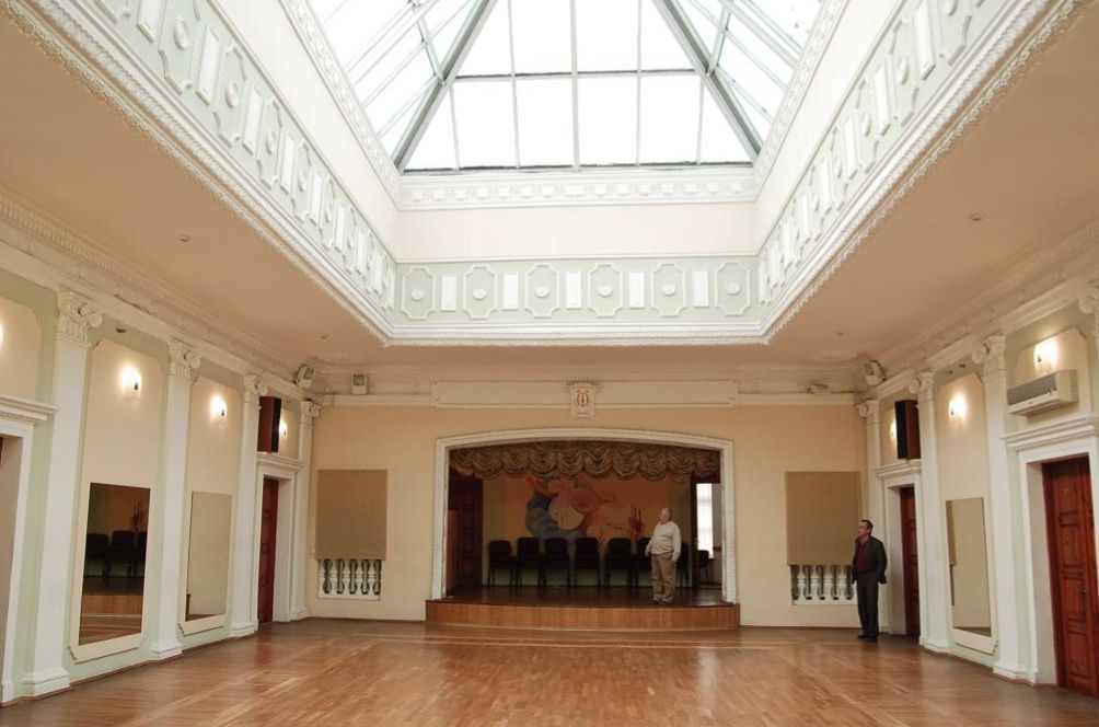 a man standing in the middle of a large room