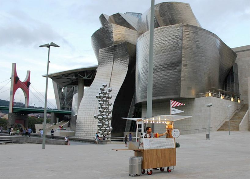 a food cart in front of a large building