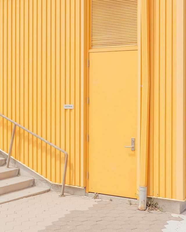 a yellow building with stairs leading up to it