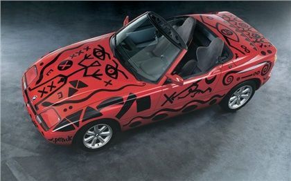 a red sports car with graffiti painted on it