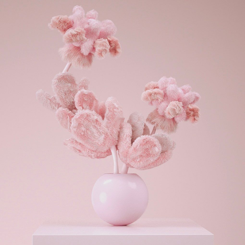 a pink vase filled with pink flowers on top of a table