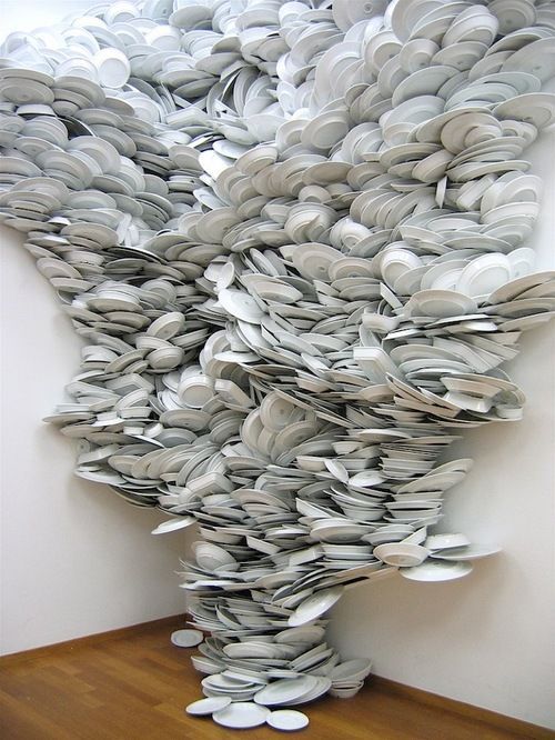 a sculpture made out of books on a wooden table