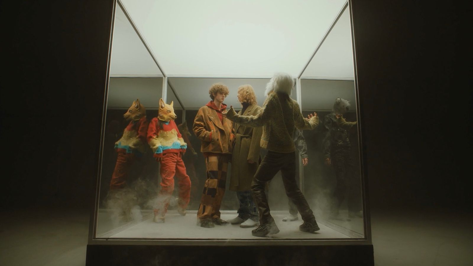 a group of people standing in a glass case