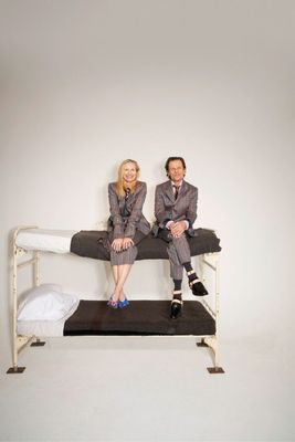 a man and a woman sitting on a bed