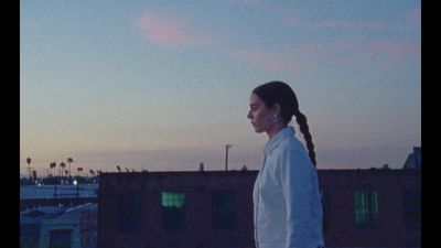 a woman with a ponytail standing in front of a building