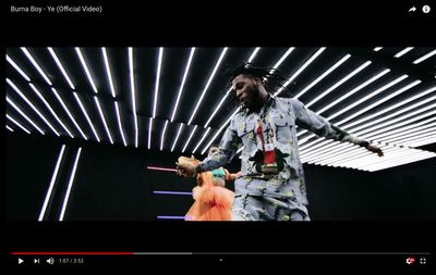 a man with dreadlocks standing in a room