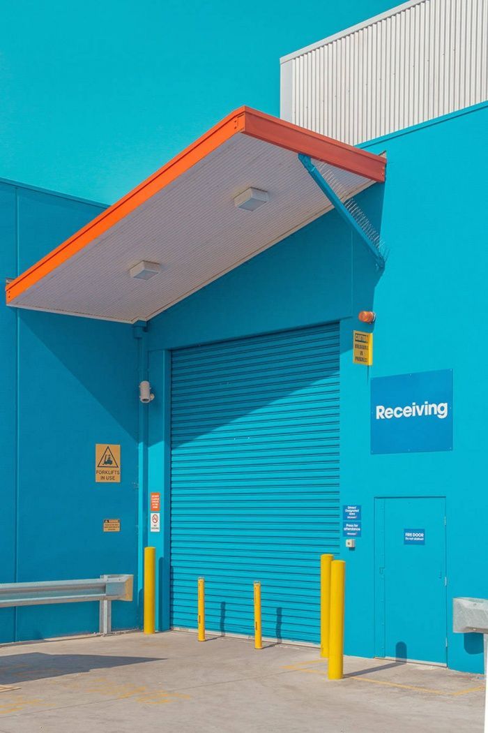 a blue building with a bench in front of it