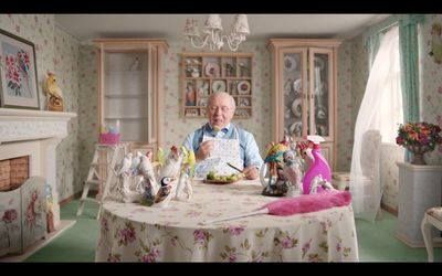 a man sitting at a table with a plate of food