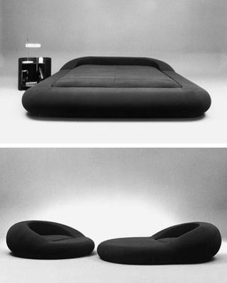 a black and white photo of a bed and a camera