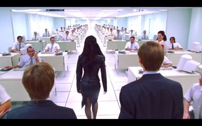 a woman walking through a room filled with people