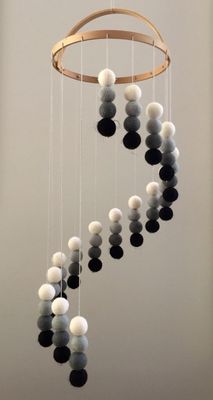 a wind chime with balls hanging from it