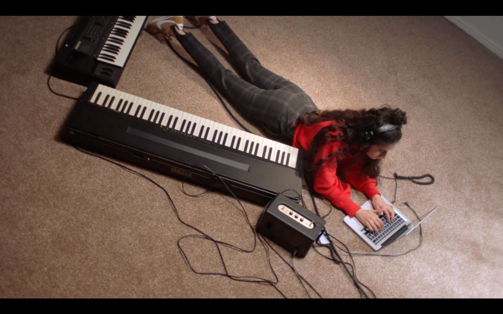 a woman laying on the floor using a laptop computer