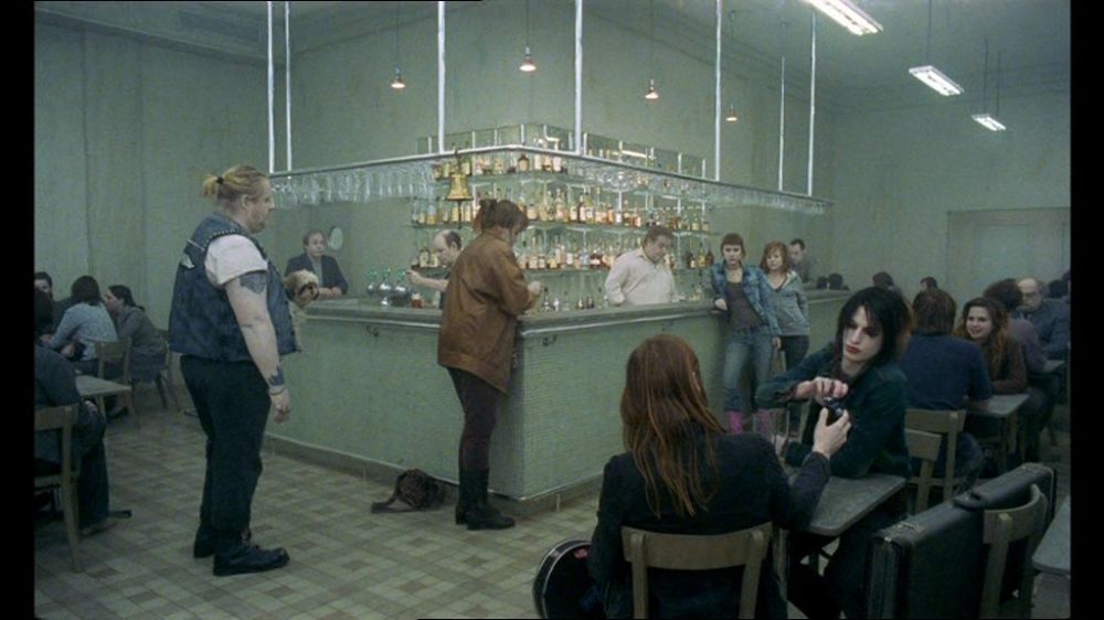 a group of people sitting around a bar