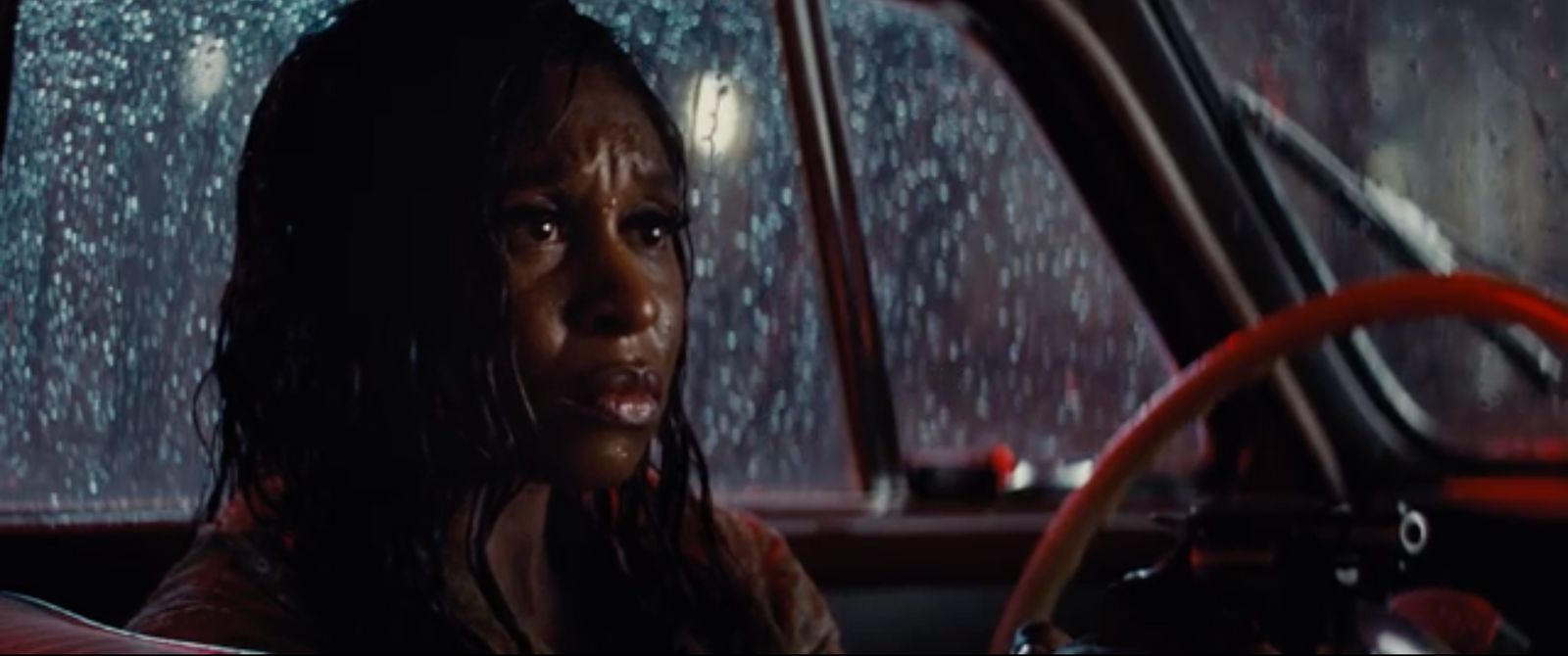 a woman driving a car in the rain