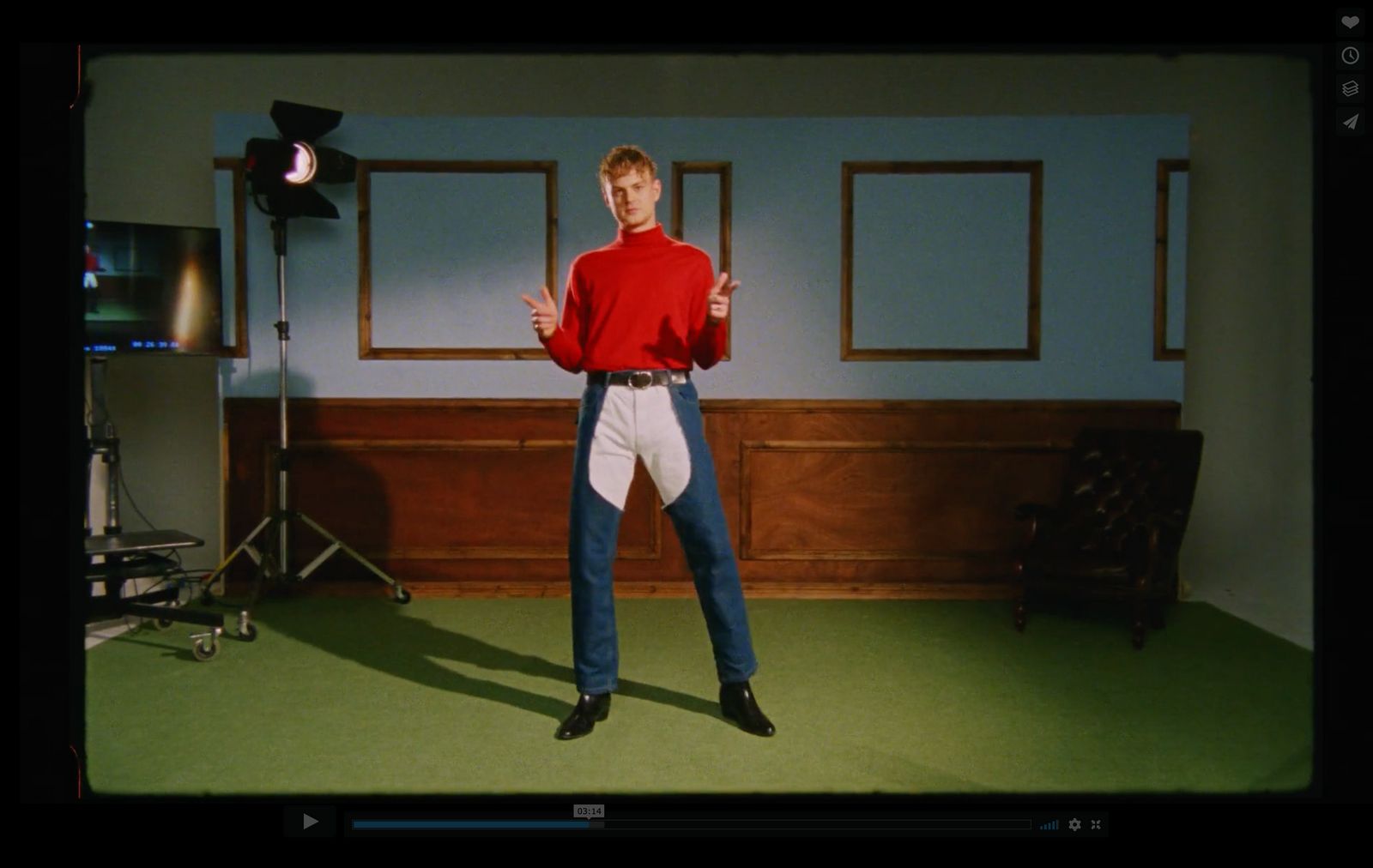 a man in a red shirt is standing in a room