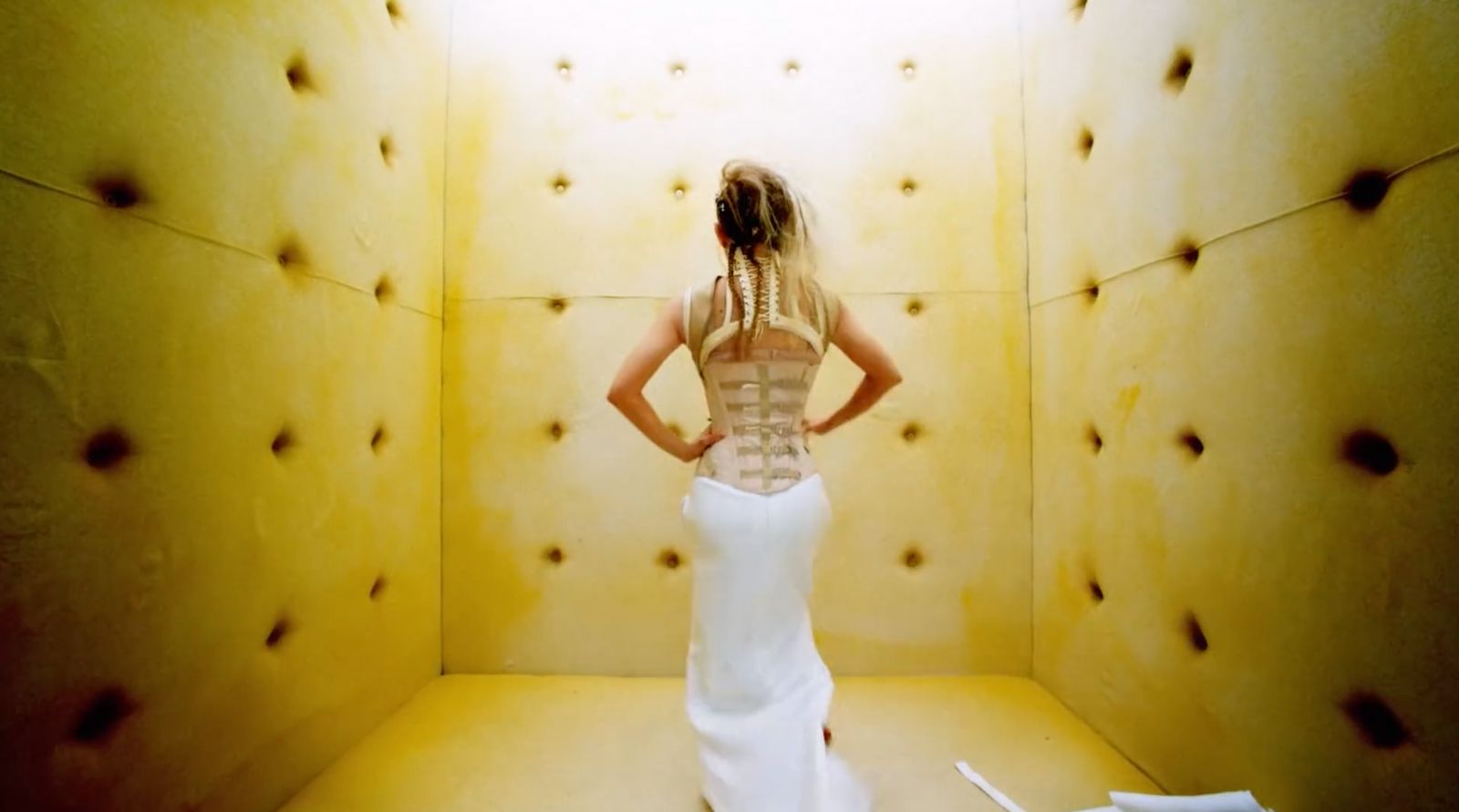 a woman in a white dress standing in a room