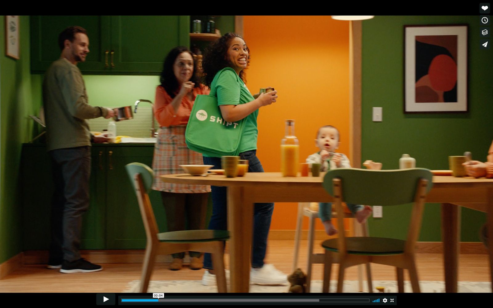 a group of people standing around a kitchen table