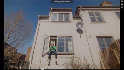 a woman sitting on a step in front of a house