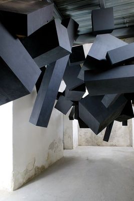 a room with a bunch of black objects hanging from the ceiling