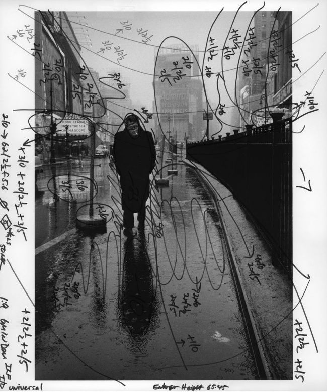 a black and white photo of a man walking down a street