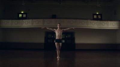 a man standing on top of a wooden floor