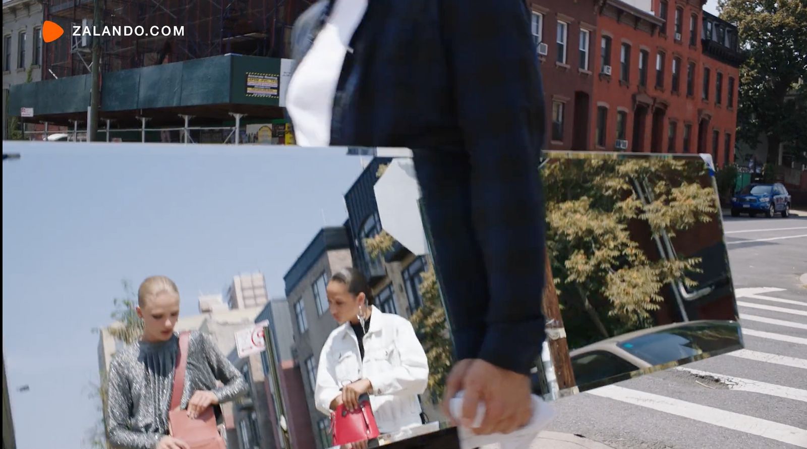 a man holding a picture of himself on the street