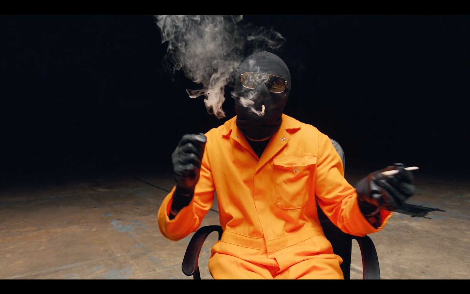 a man sitting in a chair with smoke coming out of his mouth