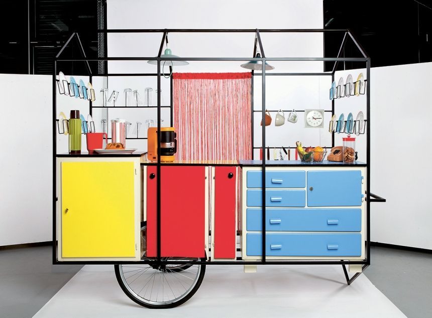 a bike is parked in front of a colorful cabinet