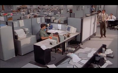 a man sitting at a desk in an office